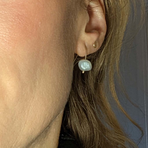 Pearl earrings worn