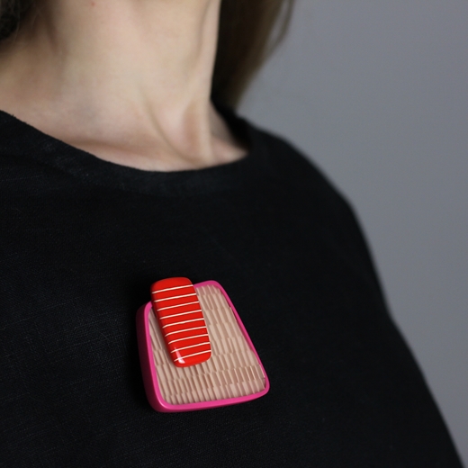 red changing stripes square brooch worn