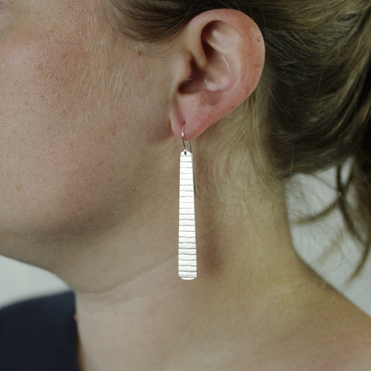 long silver stripe earrings worn