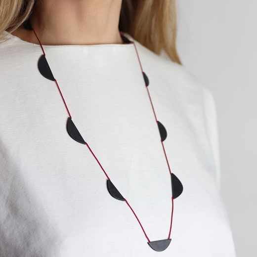 Nine boat necklace on red silk - worn