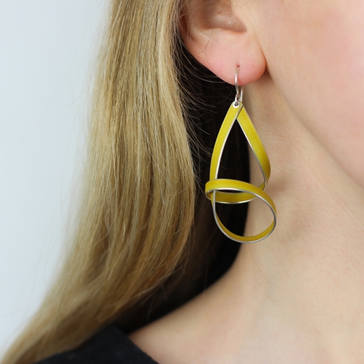 Yellow short drop ribbon earrings worn