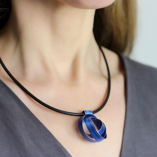 Royal blue wide ribbon coil pendant worn