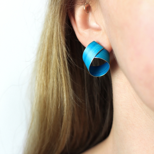 Turquoise blue wide coil stud earrings worn