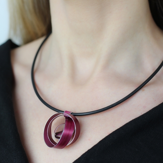 Pink wide ribbon coil pendant worn