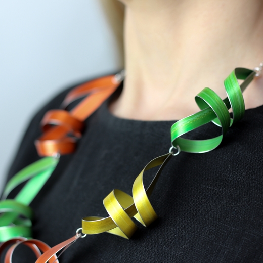 Lime, yellow and orange five long ribbon necklace worn detail