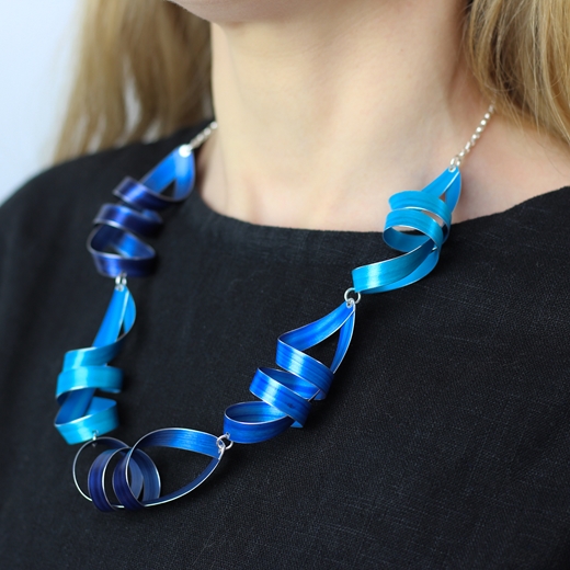 Turquoise blue, royal blue and indigo five long ribbon necklace worn