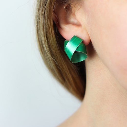 Green wide coil stud earrings worn