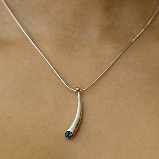 short curved silver pendant with 18ct gold bead