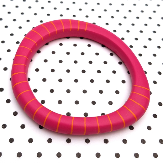 pink resin bangle with orange stripe pattern inlayed
