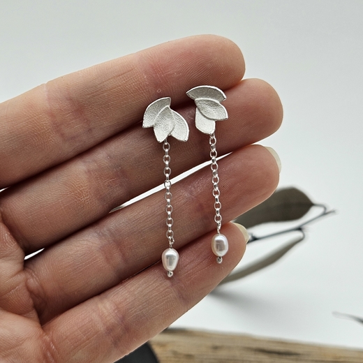 eucalyptus leaves pearl drop earrings in hand