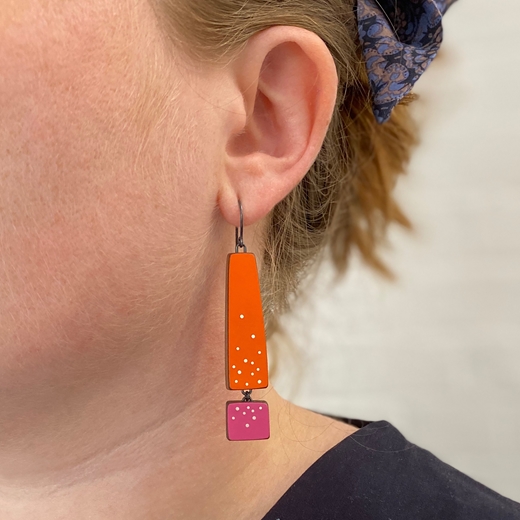 orange and pink earrings worn
