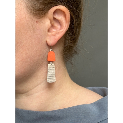 orange earrings worn