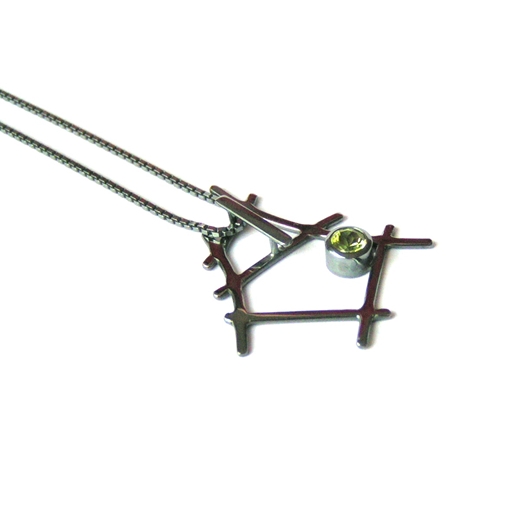 Small rutile formation pendant set with 4mm peridot side view