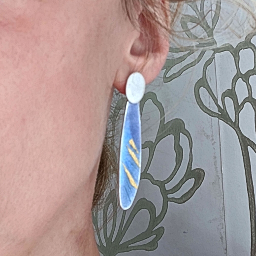 Thrive feather earring worn