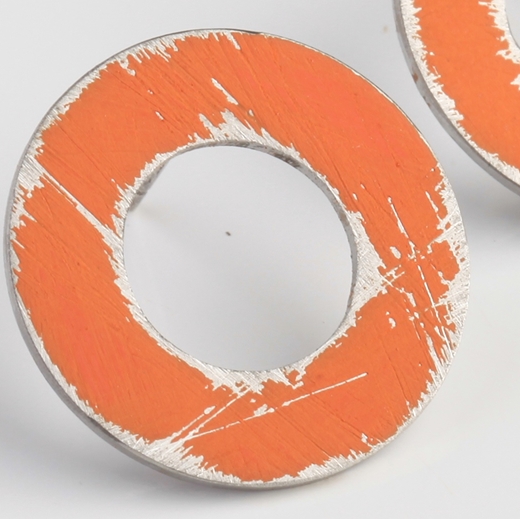 Close-up of small Orange washer earrings